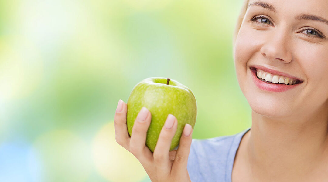girl-holding-apple-with-bright-background-header